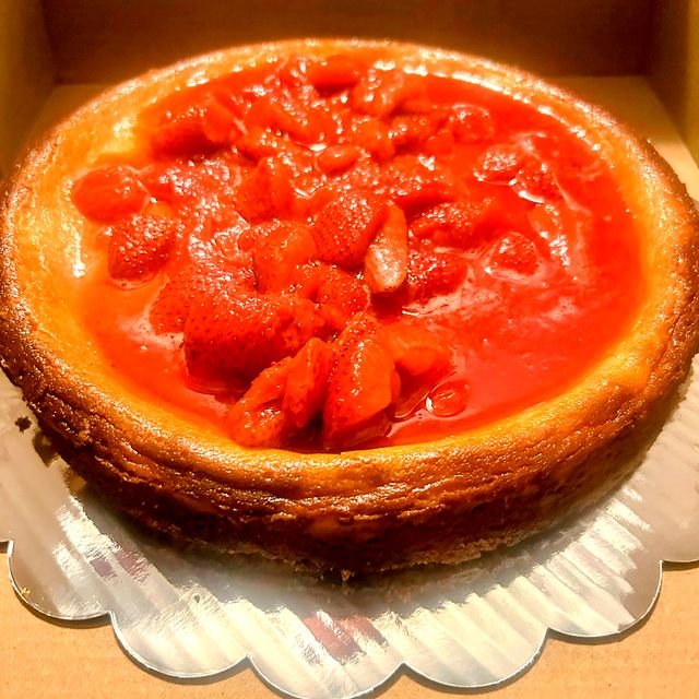 Whole cheesecake topped with strawberry filling